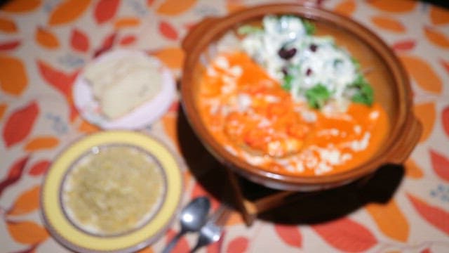 Plate of hamburger steaks soaked in sauce, with rice and bread