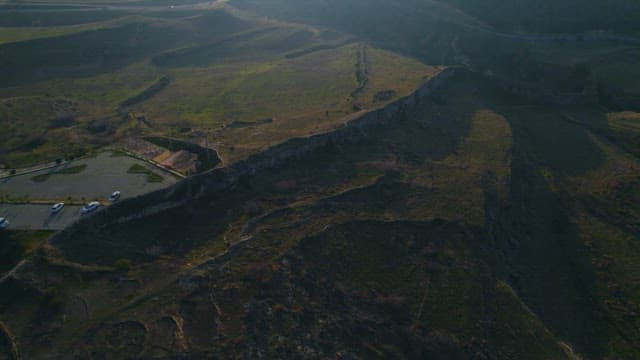 Rugged Cliffs and Wide-Open Fields under the Vast Sky