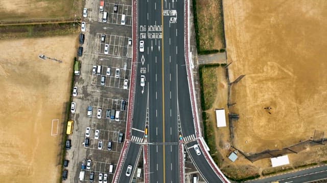Vehicles on an Overpass over the Frozen Rivers and Fields