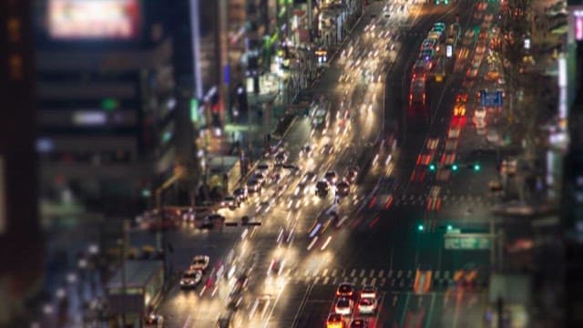 Bustling City Streets with Vehicles at Night