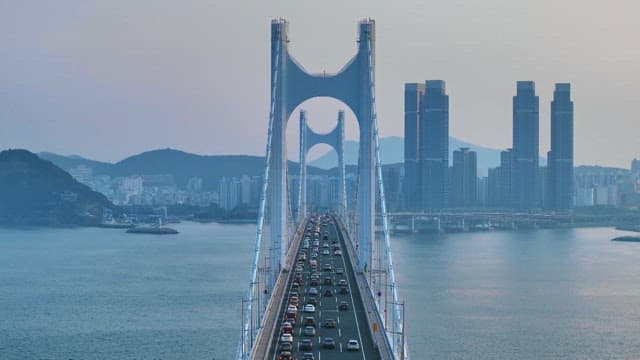 Bridge crowded with cars against the backdrop of a busy port city