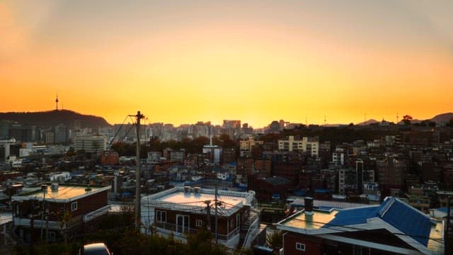 Cityscape at sunset with city buildings and electric poles
