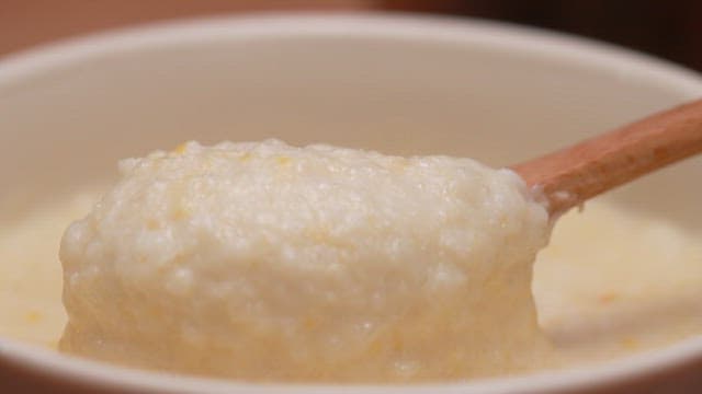 Scooping Warm Porridge with a Wooden Spoon