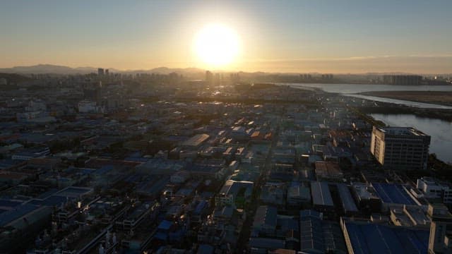 Sunset Over Urban Landscape and Sea