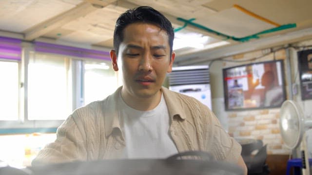 Man tasting spicy Korean stew indoors
