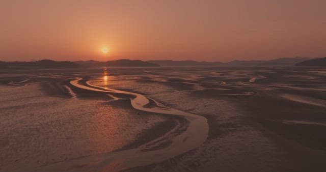 Sunset over a serene tidal flat