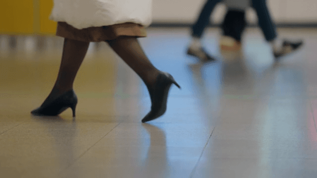 People walking in a busy indoor corridor