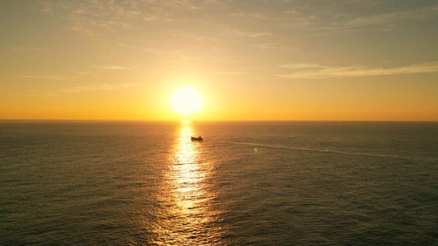 Sunset over the calm ocean horizon