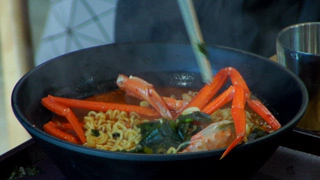Enjoying ramen with red snow crab with chopsticks