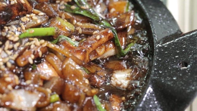 Seafood Jjajang noodles being cooked on a hot plate