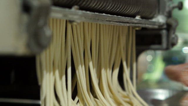 Noodle dough being processed in a machine