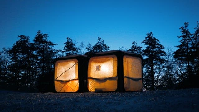 Illuminated Tent in Twilight Forest