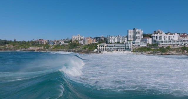 Coastal Cityscape with Turbulent Sea Waves