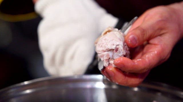 Cutting cooked chicken with scissors