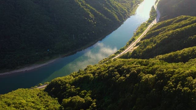 Scenic aerial view of a road by the river