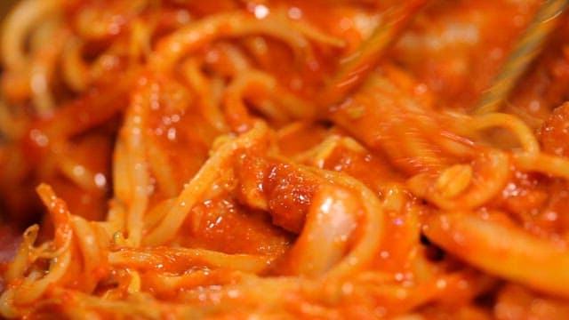 Chopstickful of crispy cheese pork cutlet with spicy sauce with bean sprouts