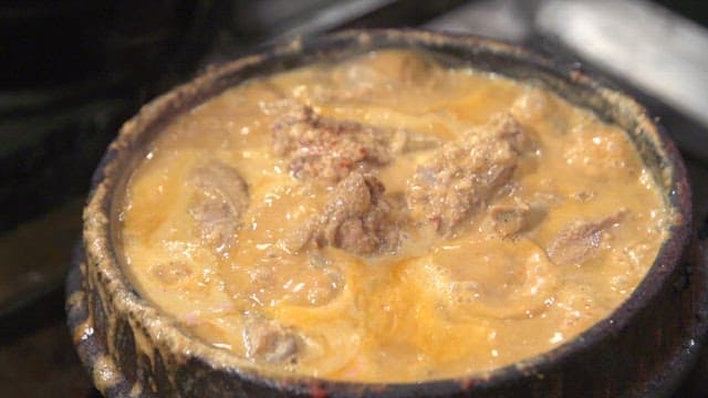 Water parsley added to boiling duck soup