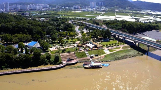 Green green belt and riverside in the background of buildings in the city