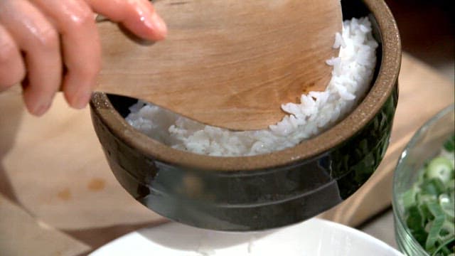 Rice and chicken being prepared in a bowl
