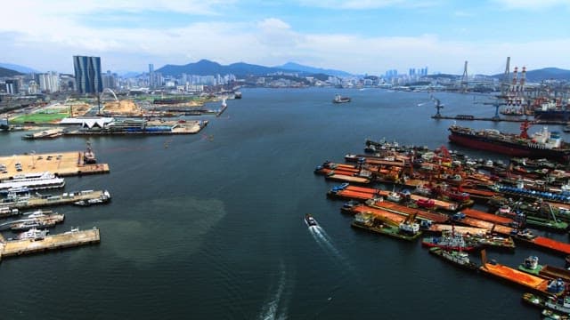 Bustling Seaport with Ships and Urban Backdrop