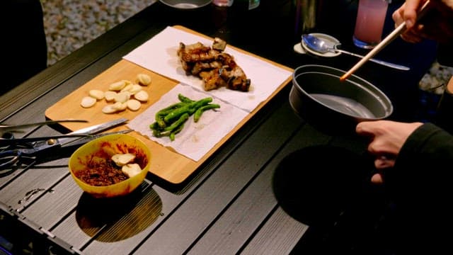 Eating grilled pork belly at a campsite