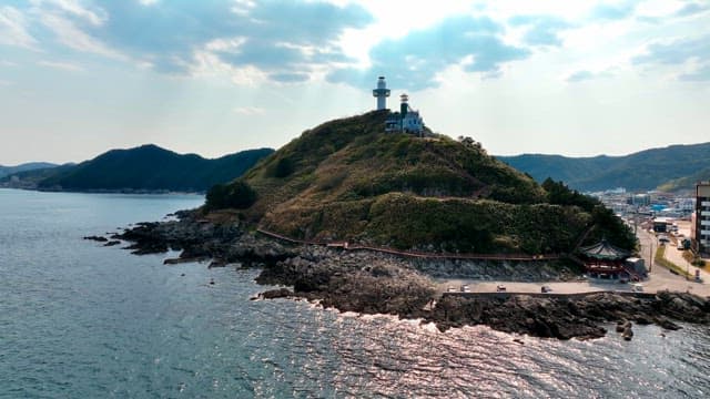 Lighthouse on a scenic coastal hill