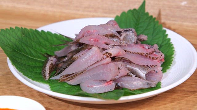 Fresh damselfish on a plate with perilla leaf