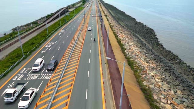 Coastal highway with cars and ocean view