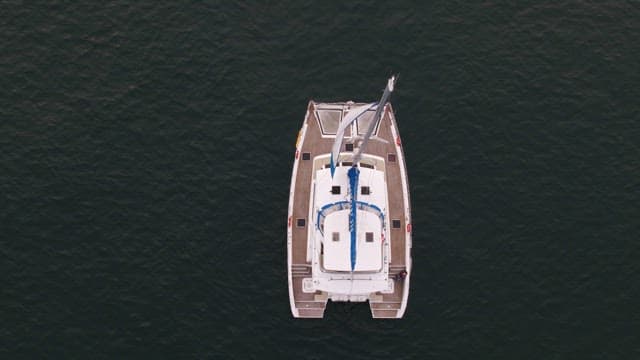 Aerial View of a Sailboat on Calm Waters