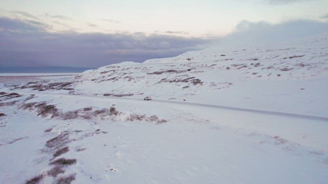 Car driving through a snowy landscape