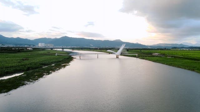 Serene river with a modern bridge