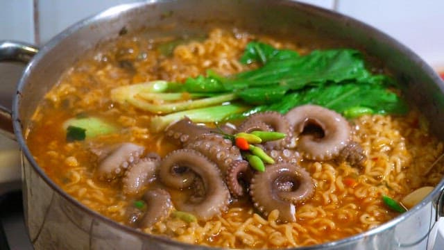 Korean seafood ramen with octopus boiling in a pot