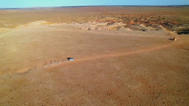 Vehicle Crossing the Vast Desert