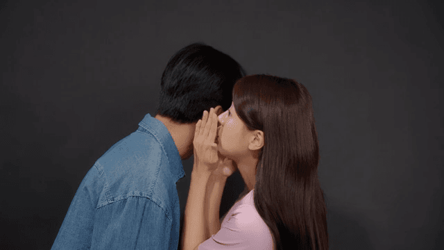 Man and a woman talking quietly, whispering and sharing secrets