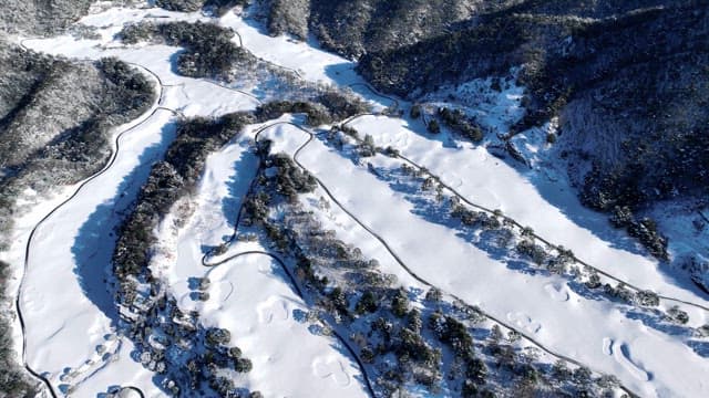 Snow-covered mountains with twisting roads