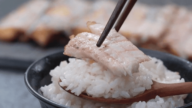 Spoonful of rice with deliciously cooked grilled hairtail