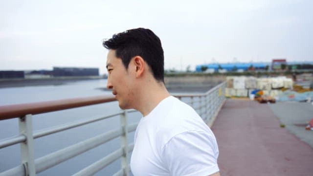 Man leaning on the railing and sighing