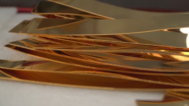 Stack of shiny golden metal sheets