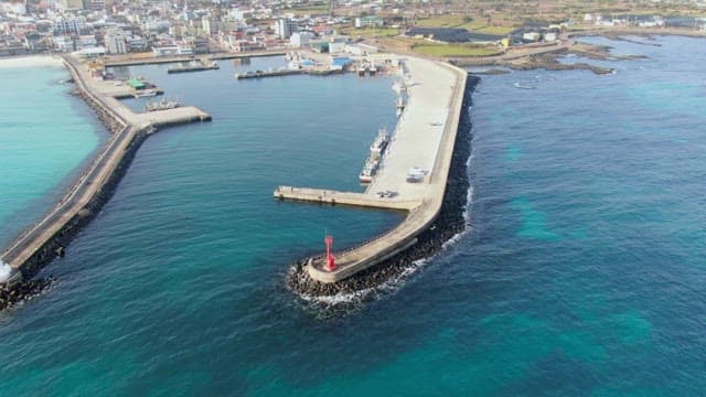 Coastal city with a long pier and boats