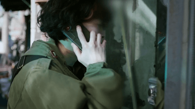 Woman standing outside a building, concerned