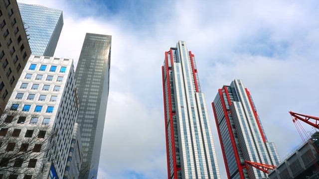Modern skyscrapers reaching into cloudy sky