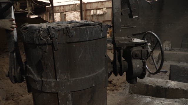 Workers handling machinery in a factory