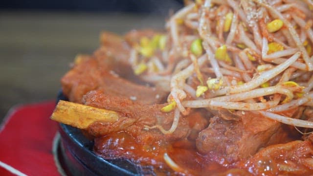Hot and spicy pork ribs and bean sprouts being cooked
