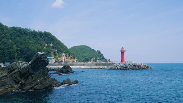 Serene Seascape with a Red Lighthouse