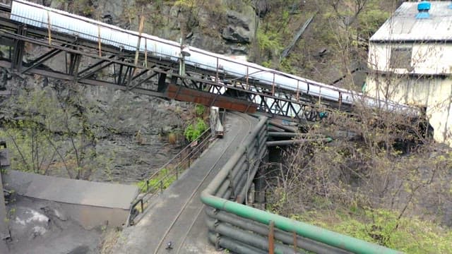 Path leading to a mine entrance on a steep mountainside