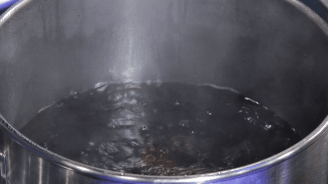 Black sauce boiling in a sot