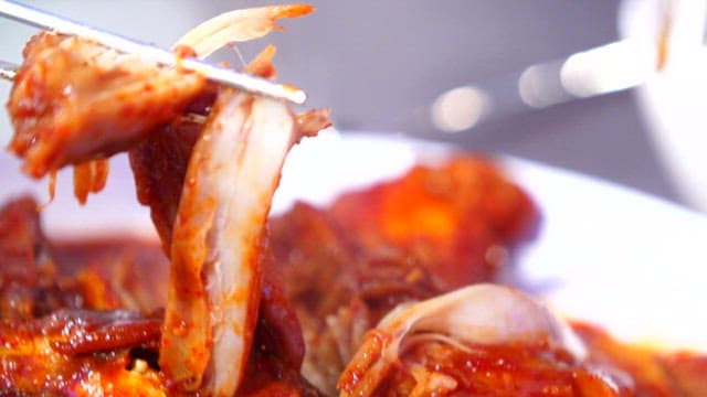 Spicy steamed ray picked up with chopsticks