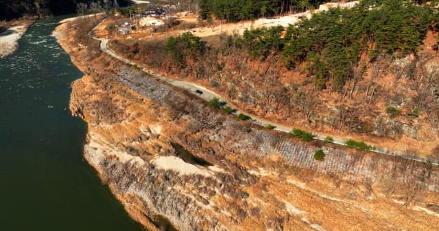 Aerial View of a Scenic Road by a River