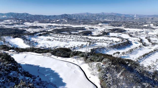Snow-covered Landscape with Winding River