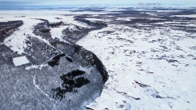Snow-covered landscape with cliffs